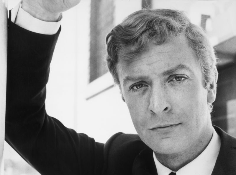 1966: Portrait of British actor Michael Caine leaning on one arm in a still from director Lewis Gilbert's film, 'Alfie'. (Photo by Paramount Pictures/Getty Images)